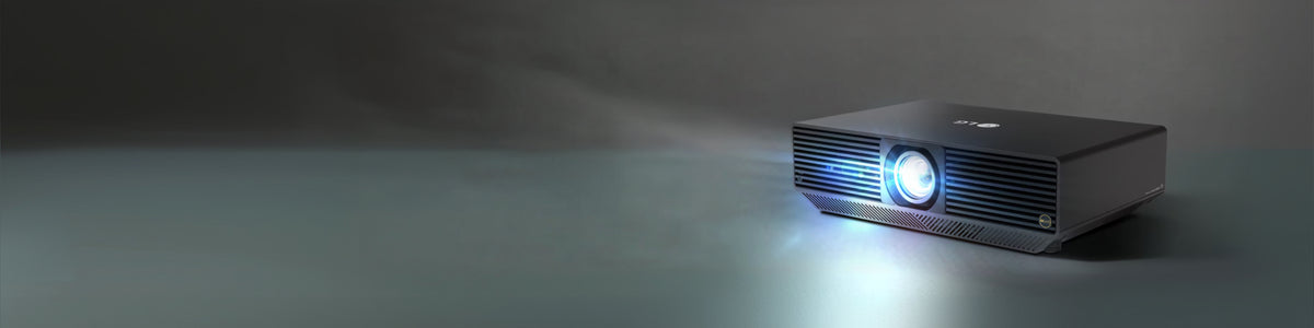 LG BU70QGT projector with light emitting from its lens against a dark background.